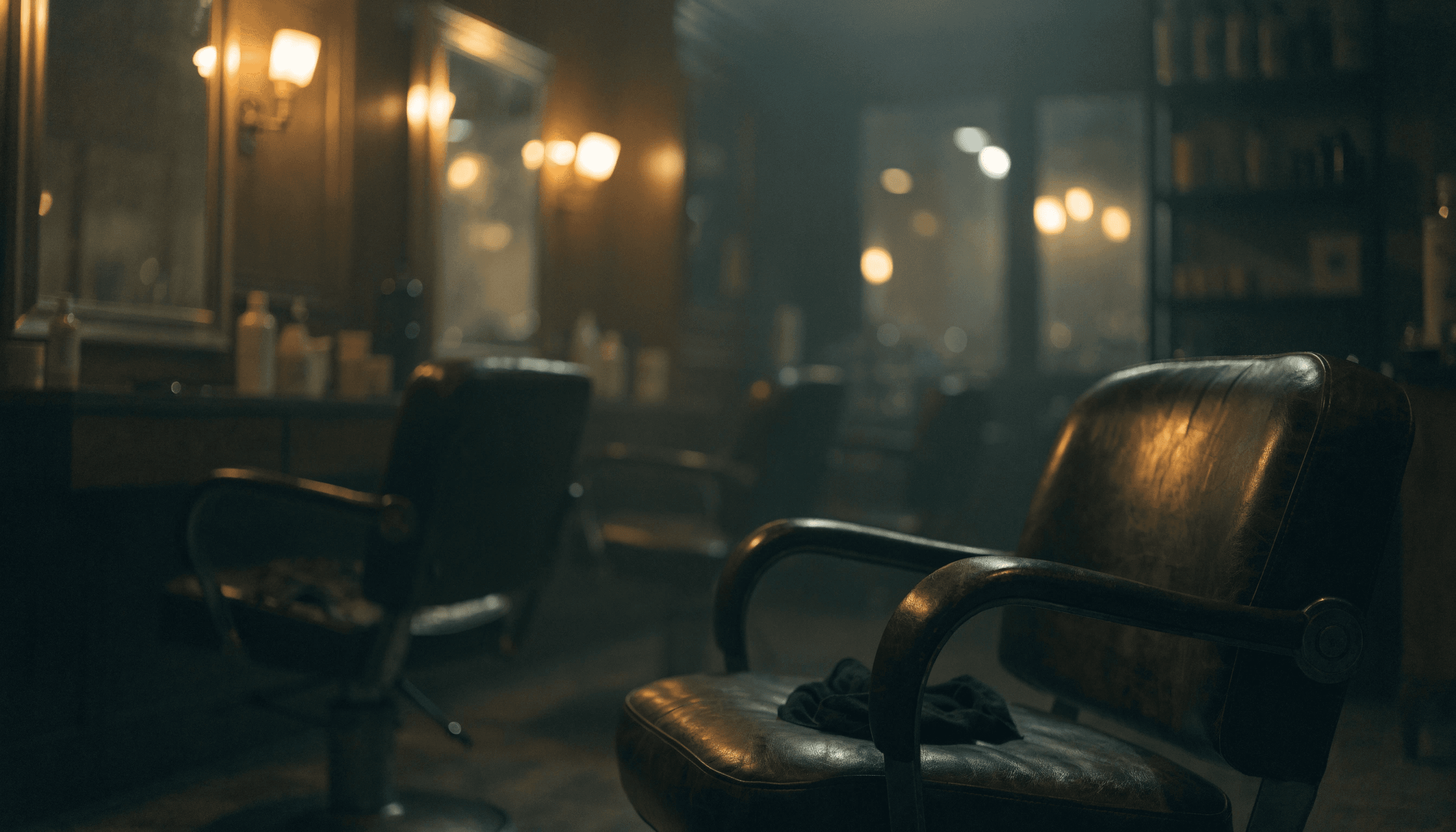 An empty barbershop at the end of the day, warm sconce lights and a vintage chair in the foreground